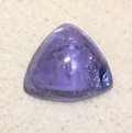 triangular 3.03ct blue-violet tanzanite cabochon on soft surface
