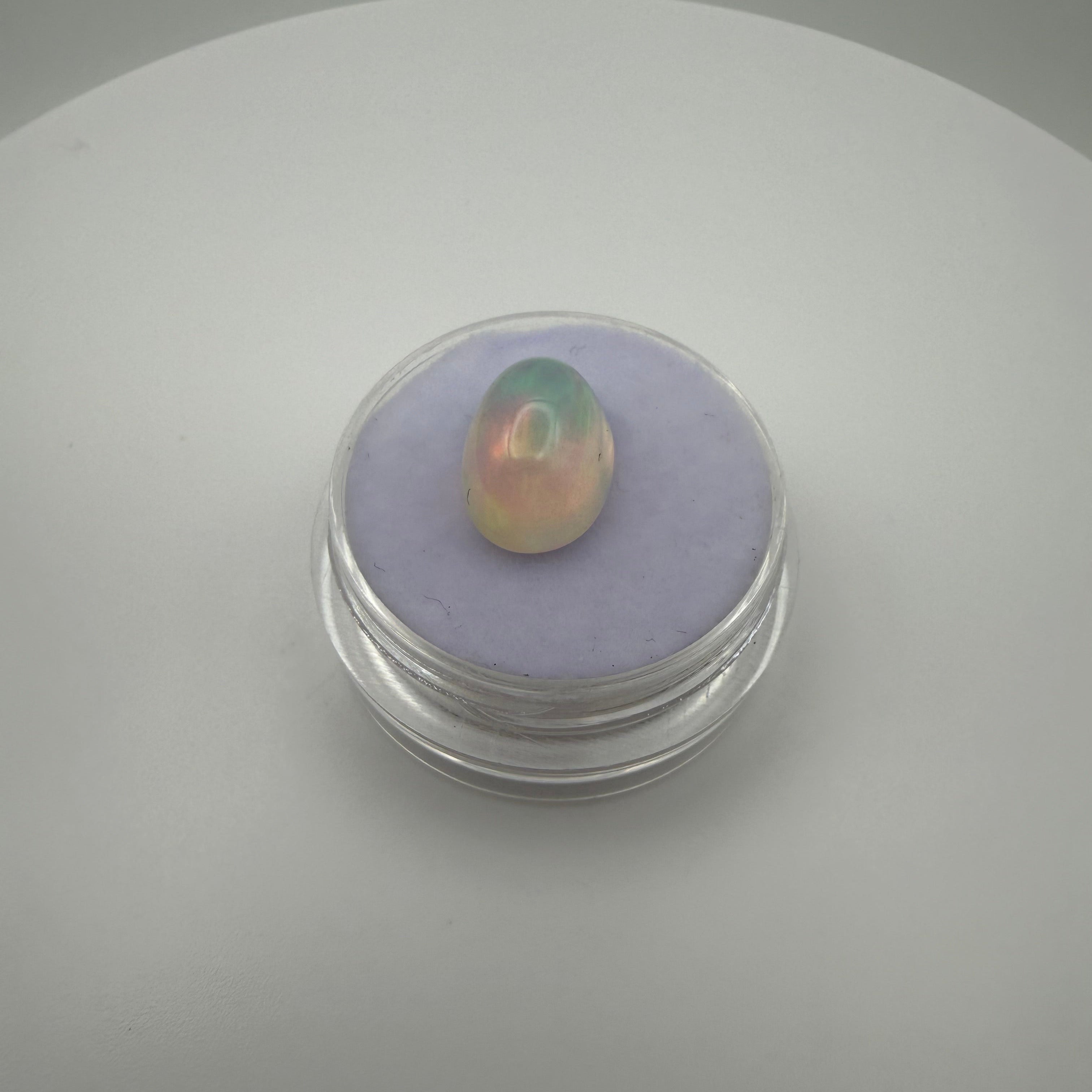 A fiery 3 carat welo opal in a gemstone holder