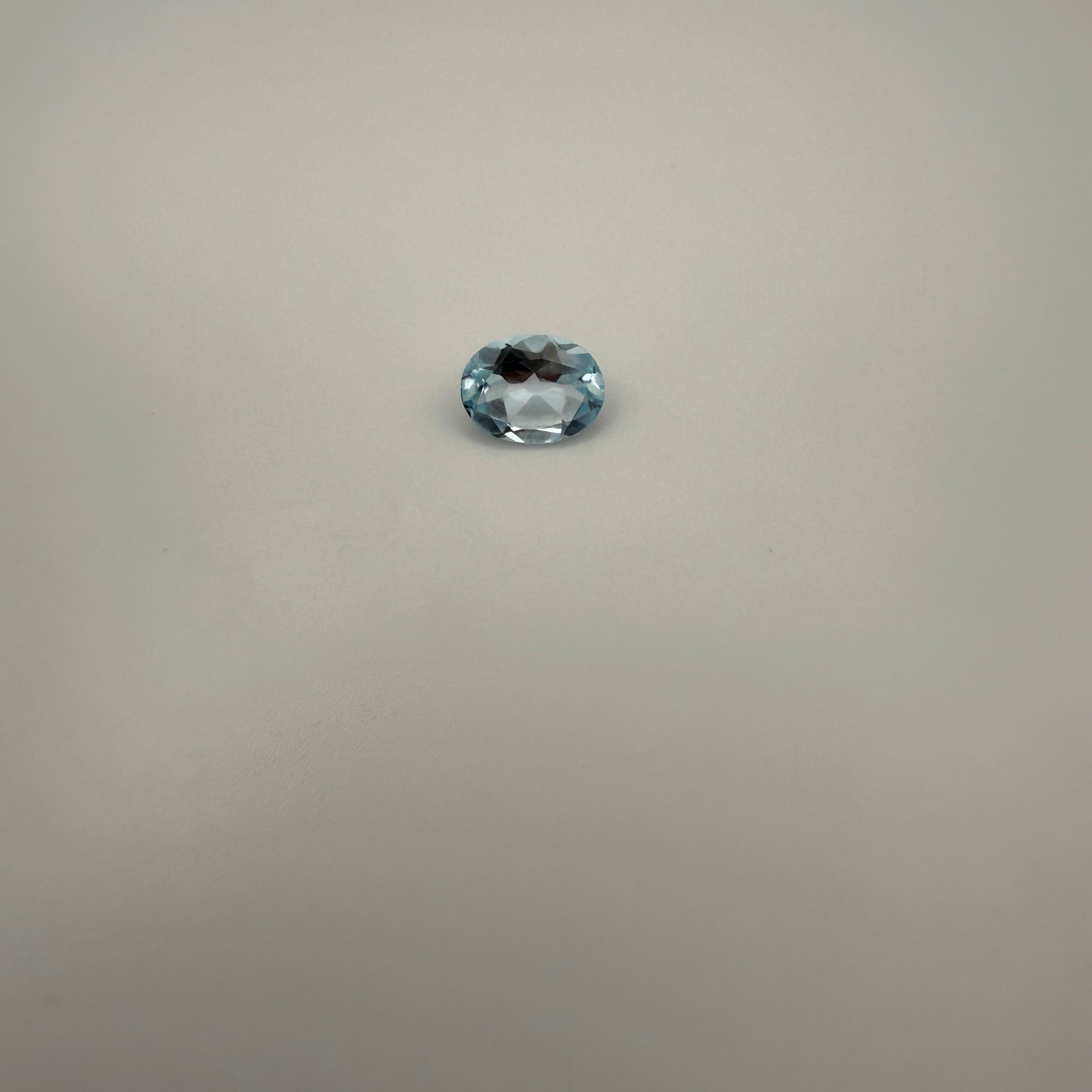 oval Swiss Blue Topaz gemstone on a light background