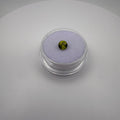macro top view of 0.45ct yellow-green peridot round faceted gemstone in a clear holder on purple cushion backdrop