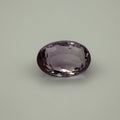 Purple gemstone on a light gray background