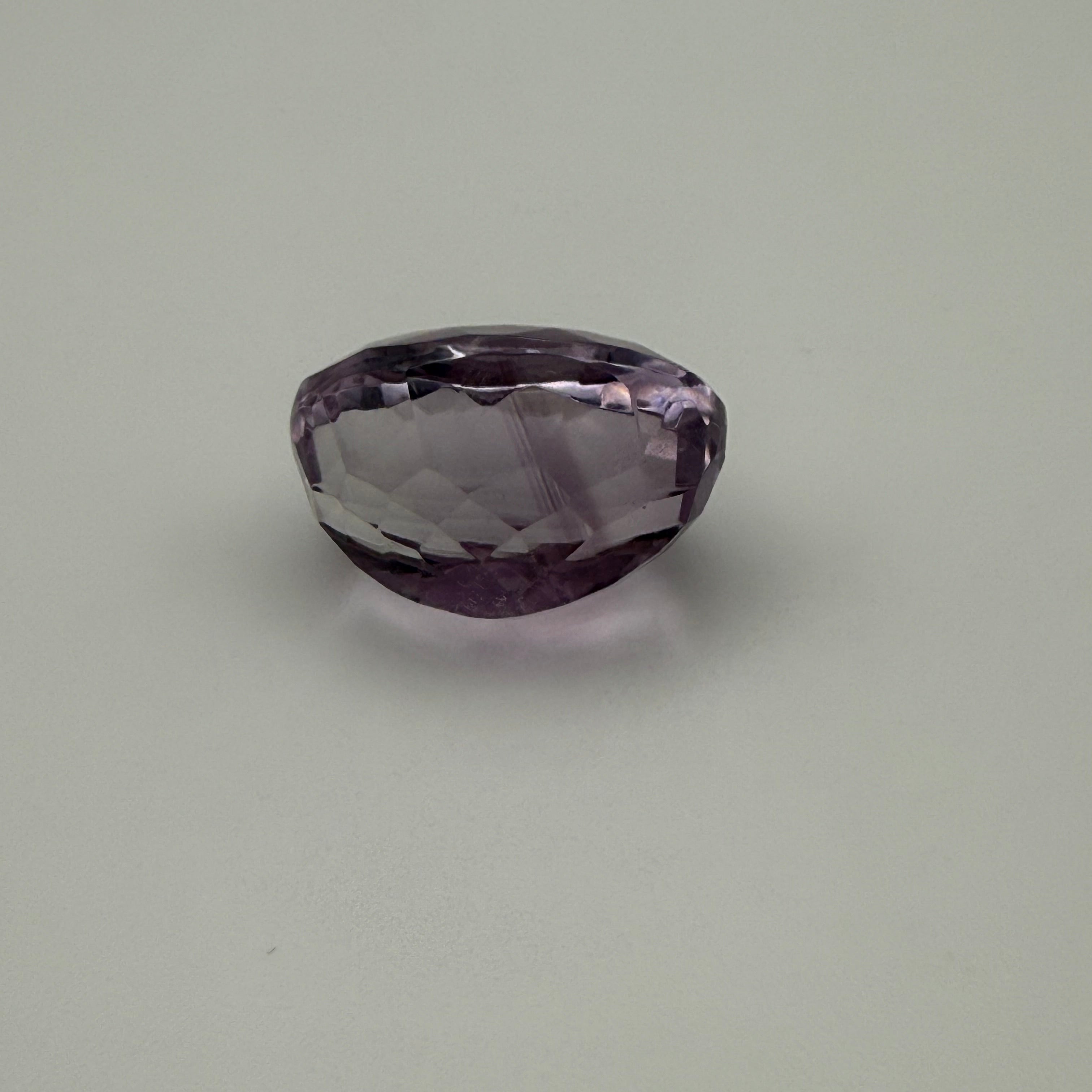 Purple gemstone on a gray background