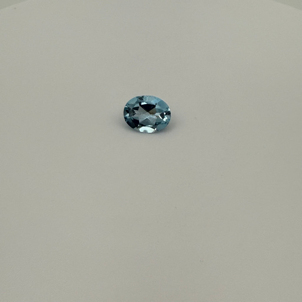 oval faceted 2.0ct Swiss Blue Topaz gemstone on a light surface