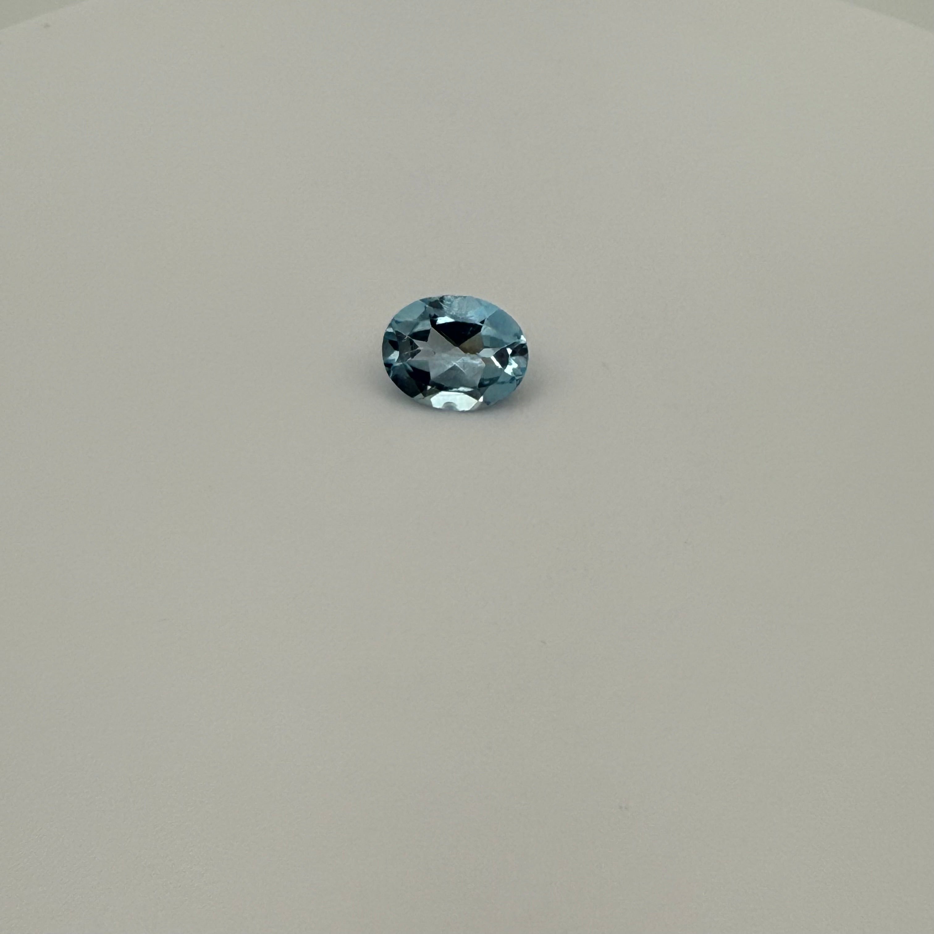 oval faceted 2.0ct Swiss Blue Topaz gemstone on a light surface