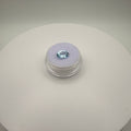 Macro top-down view of a 1.95ct Swiss Blue Topaz oval faceted gemstone on a lavender cushion in a clear display holder.